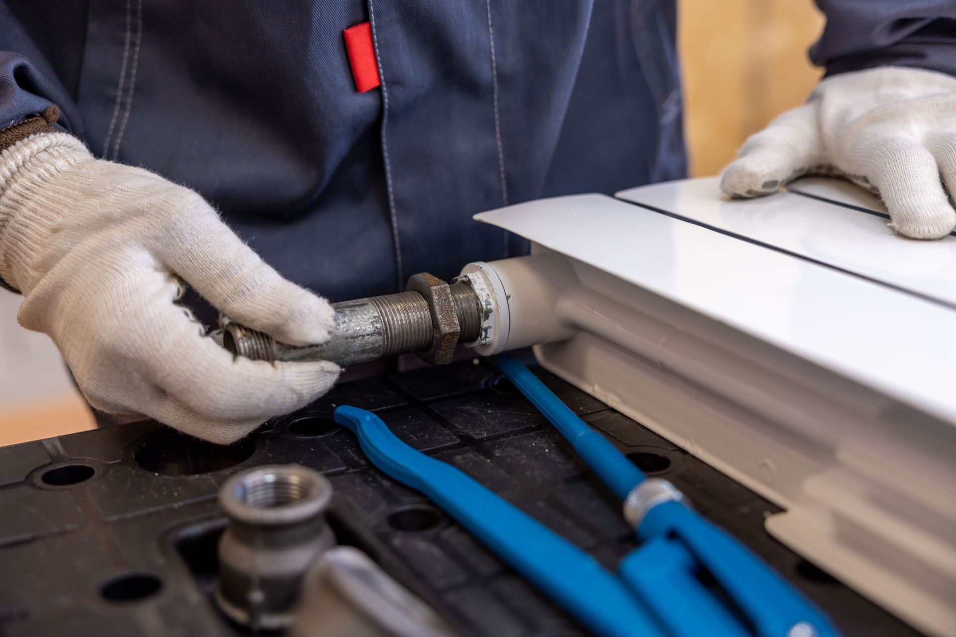 Engineer connecting a radiator pipe